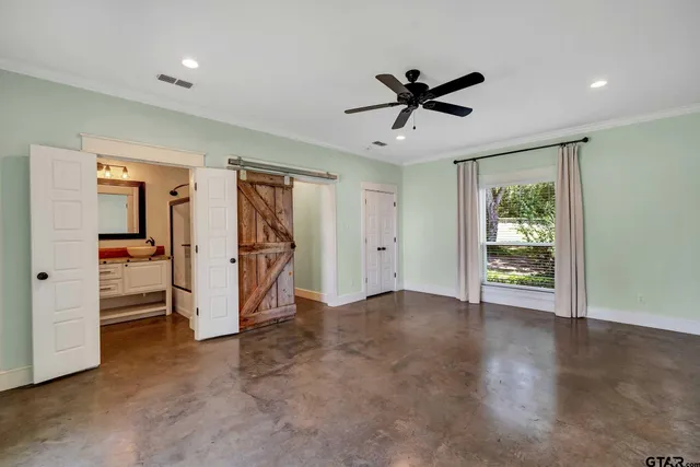 a view of a livingroom with a ceiling fan & entryway
