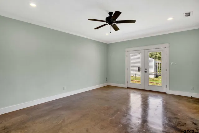 a view of room with hardwood floor and ceiling fan