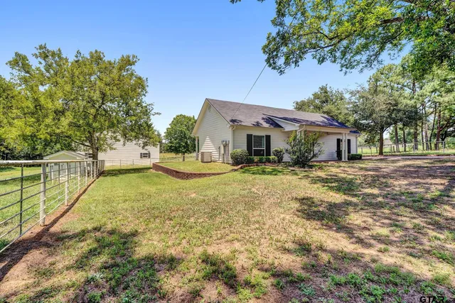 a house view with swimming pool in front of it