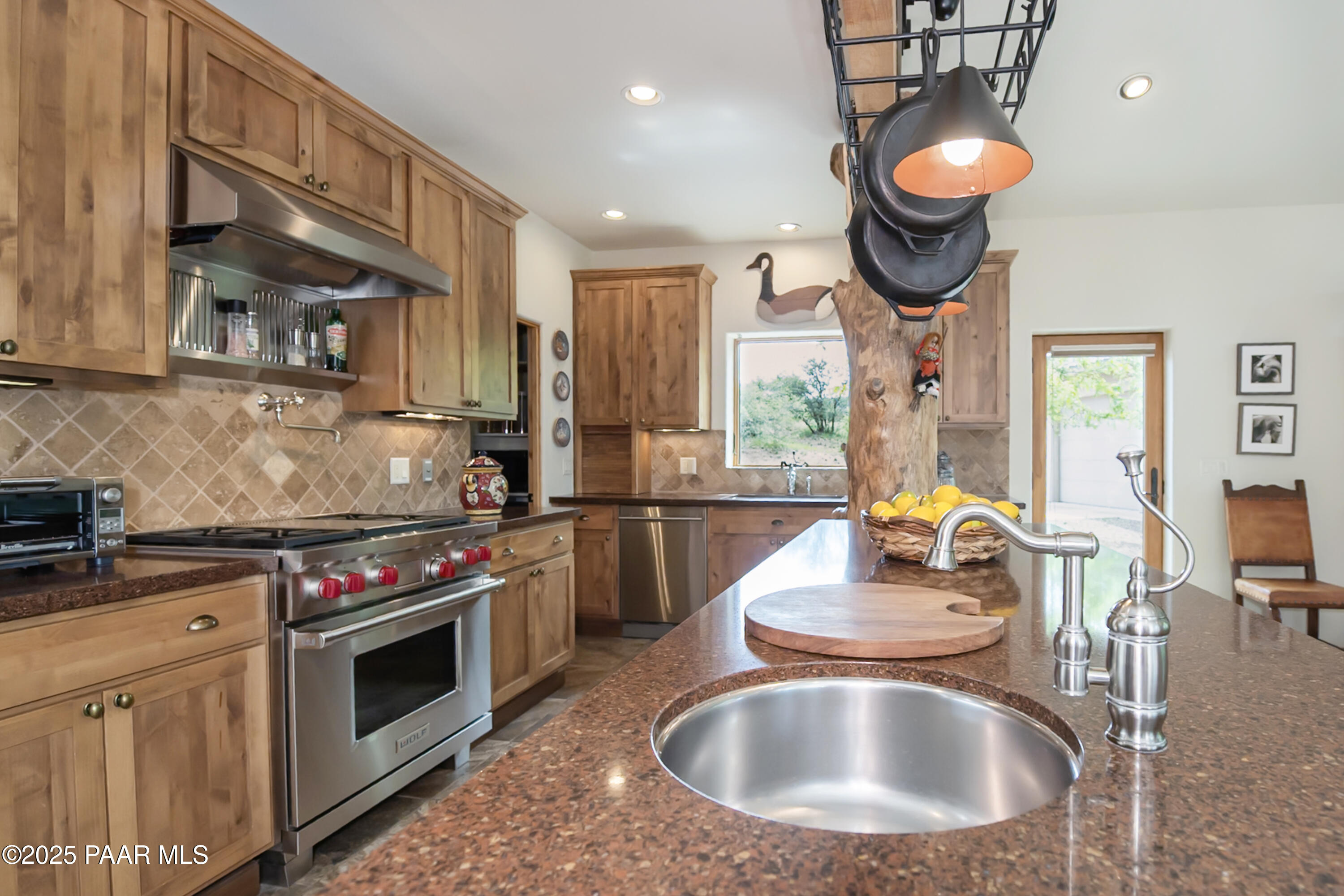 770 Grisby Road Skull Valley, AZ 86338 - Photo 9 of 58 a kitchen with kitchen island granite countertop a sink a stove and a wooden floors