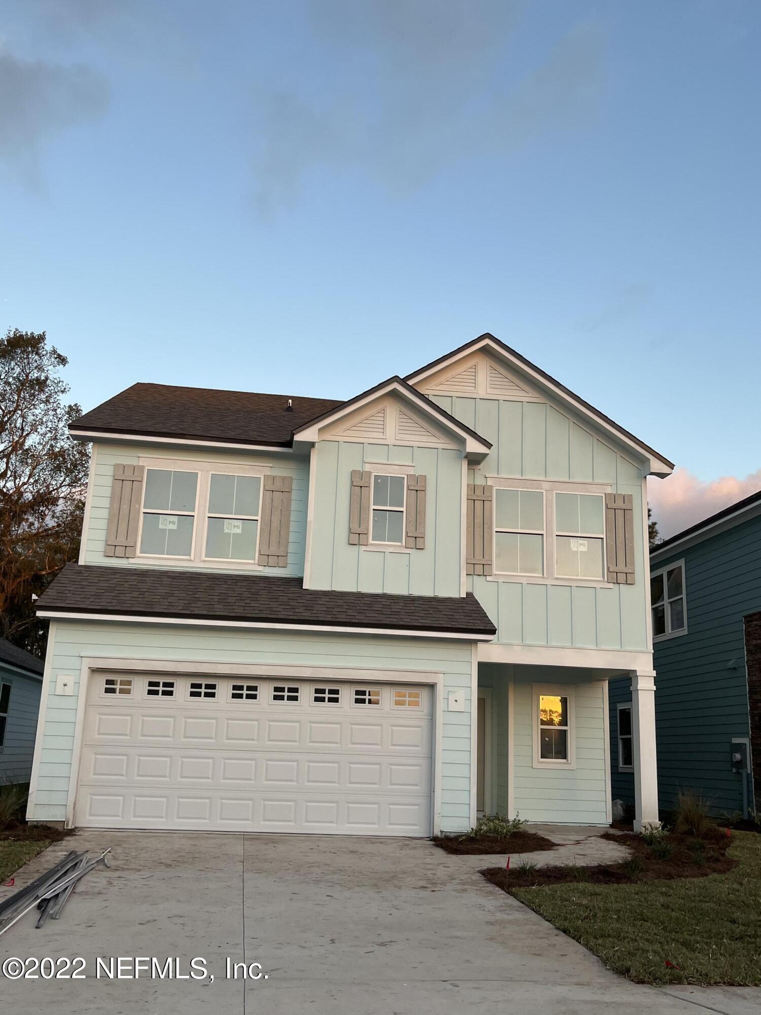 3111 Orange Picker Road Jacksonville, FL 32223 - Photo 2 of 5 a front view of a house with a yard and garage