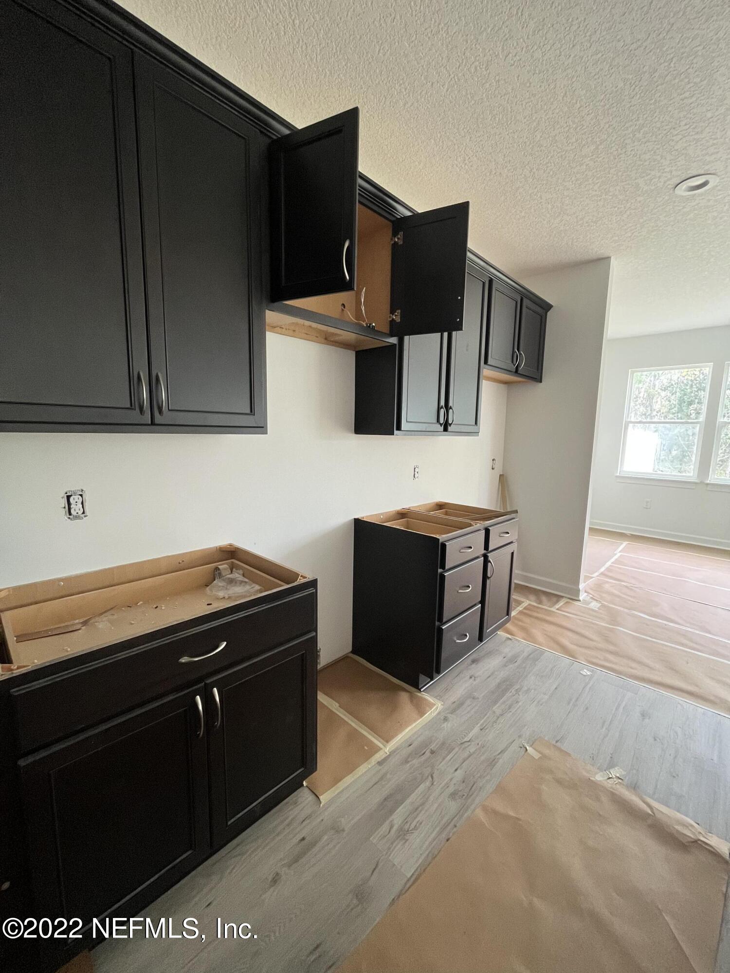 3111 Orange Picker Road Jacksonville, FL 32223 - Photo 4 of 5 a kitchen with a sink and a stove top oven