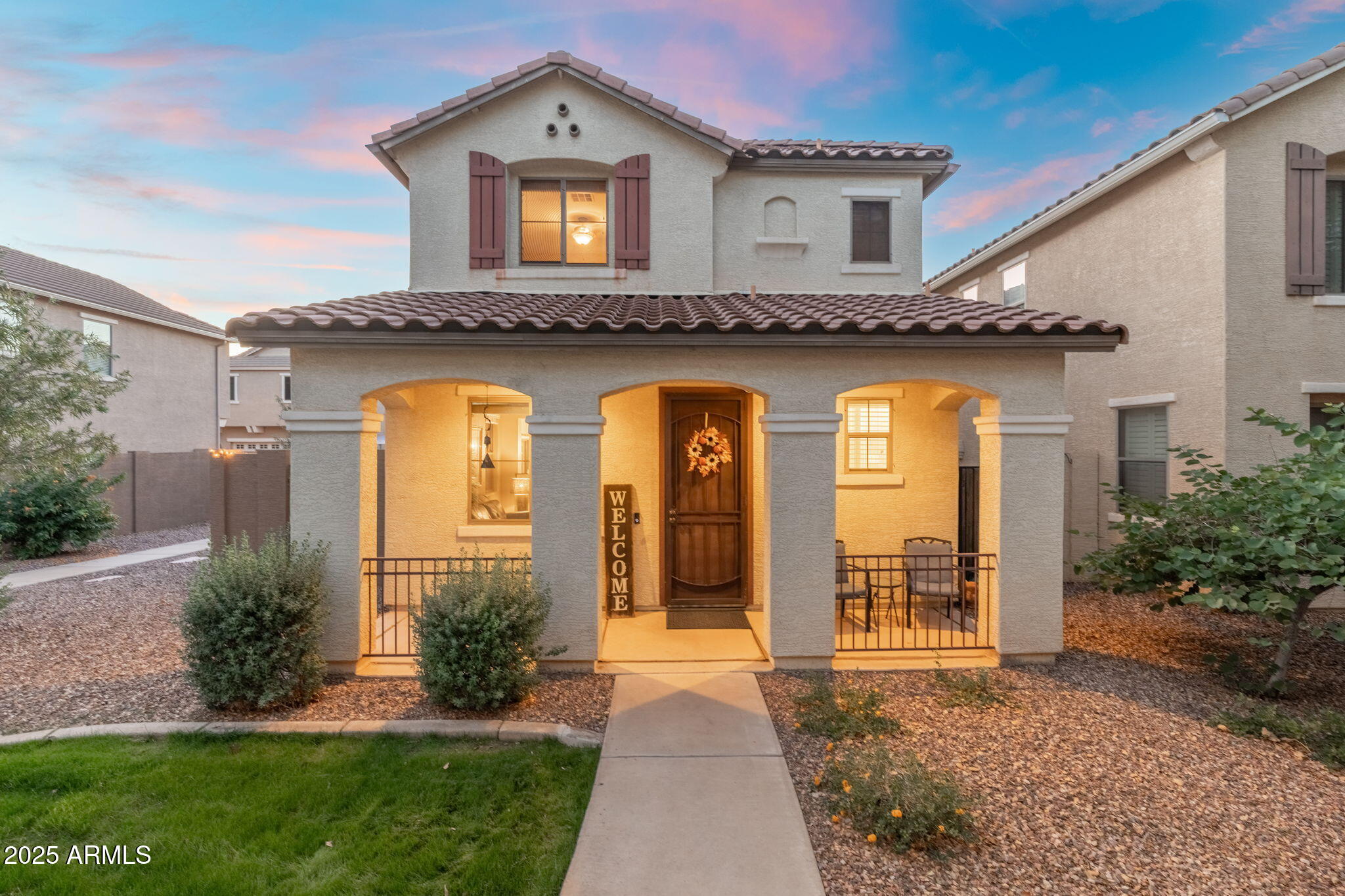 a view of a house with brick walls and a yard with plants