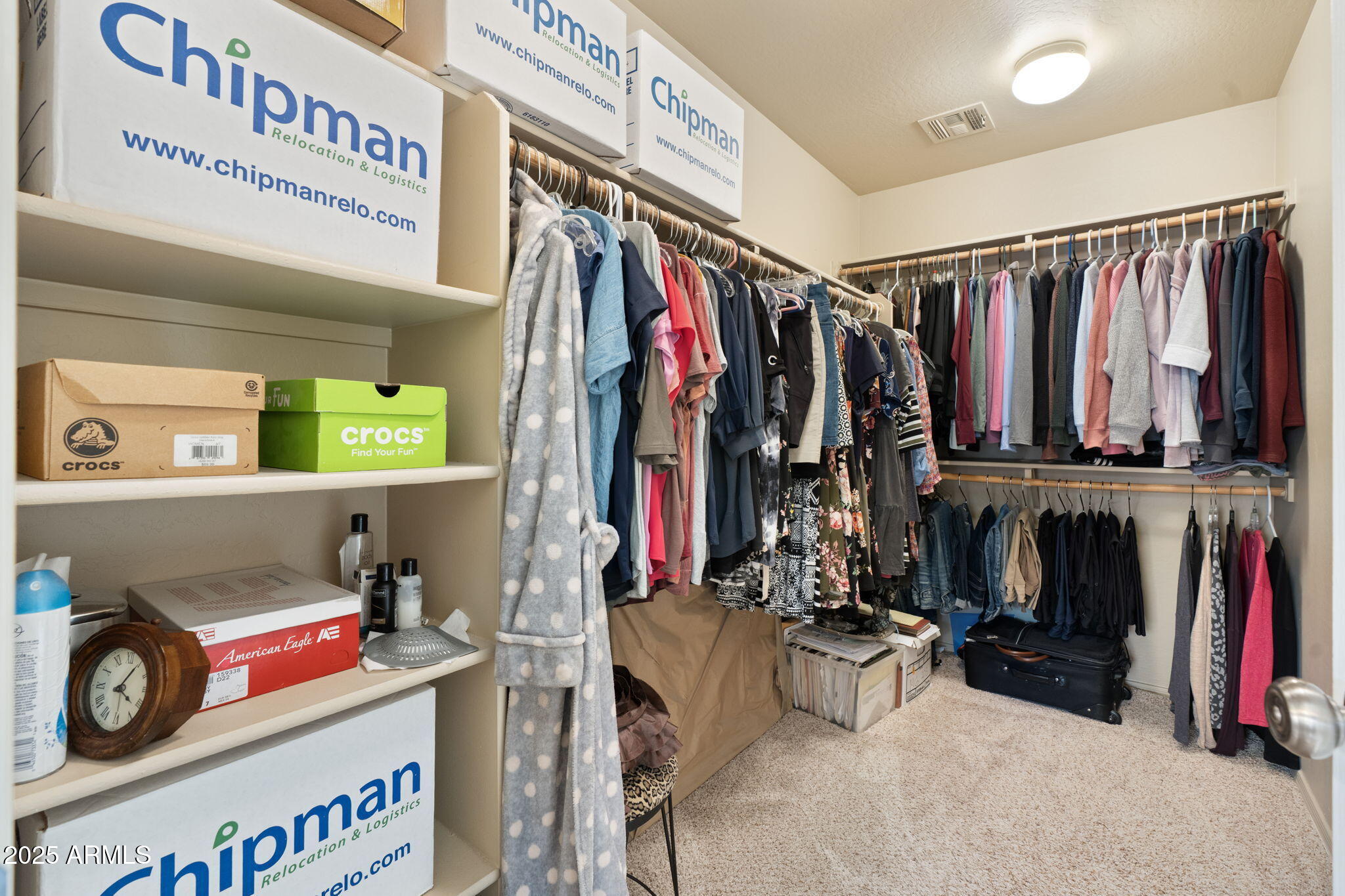 1705 East Joseph Way Gilbert, AZ 85295 - Photo 20 of 39 a view of walk in closet with clothes and shoes