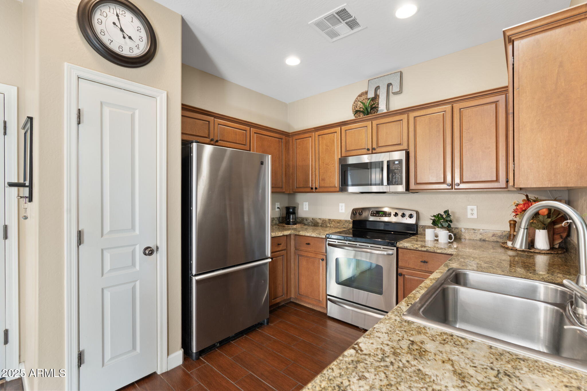 1705 East Joseph Way Gilbert, AZ 85295 - Photo 9 of 39 a kitchen with stainless steel appliances granite countertop a refrigerator a stove top oven a sink and dishwasher