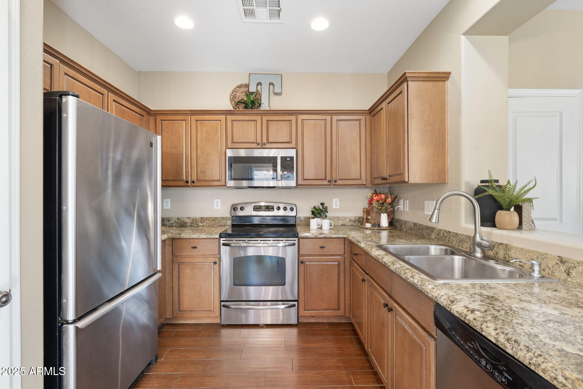 1705 East Joseph Way Gilbert, AZ 85295 - Photo 10 of 39 a kitchen with stainless steel appliances granite countertop a refrigerator stove microwave and sink
