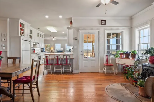a room with stainless steel appliances kitchen island granite countertop furniture and a livingroom view