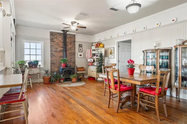 a living room with furniture a chandelier and a dining table