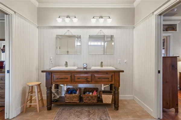 a utility room with stainless steel appliances kitchen island a table and chairs in it