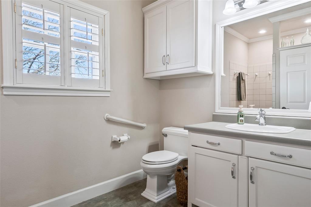 14410 Fm 455 Street West Decatur, TX 76234 - Photo 23 of 40 a bathroom with a toilet a sink a vanity and mirror