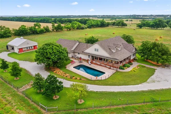 an aerial view of a house with garden space and outdoor seating