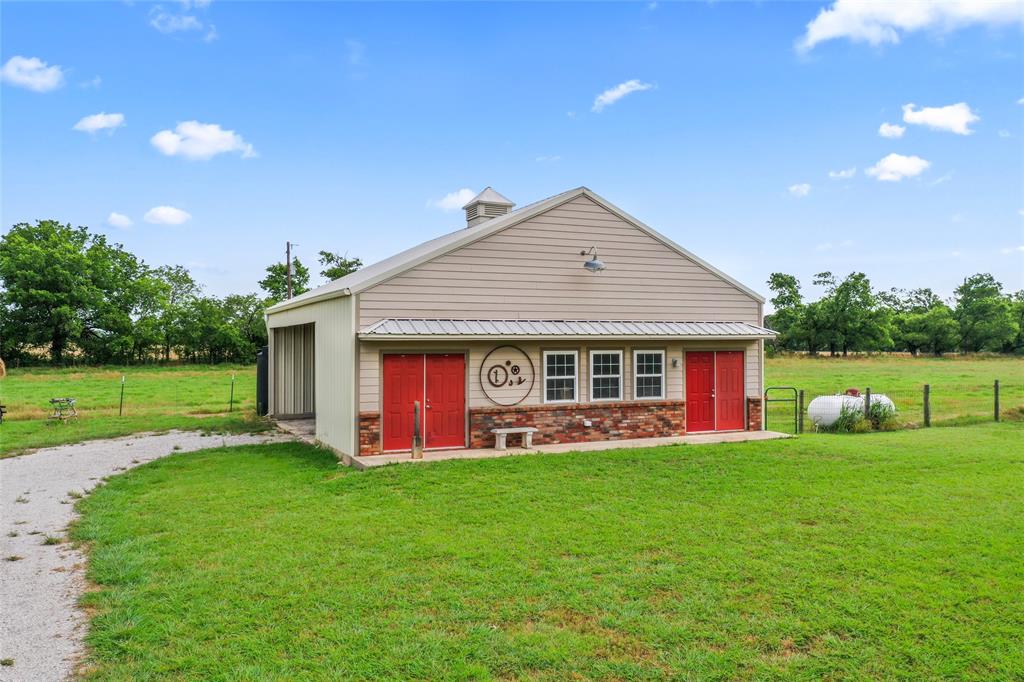 14410 Fm 455 Street West Decatur, TX 76234 - Photo 5 of 40 a front view of a house with a yard and garage