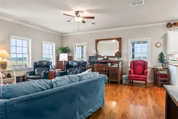 a living room with furniture and wooden floor