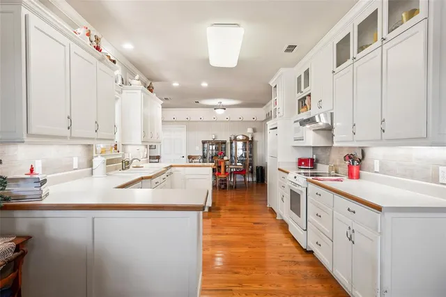 a kitchen with stainless steel appliances granite countertop lots of counter top space and cabinets