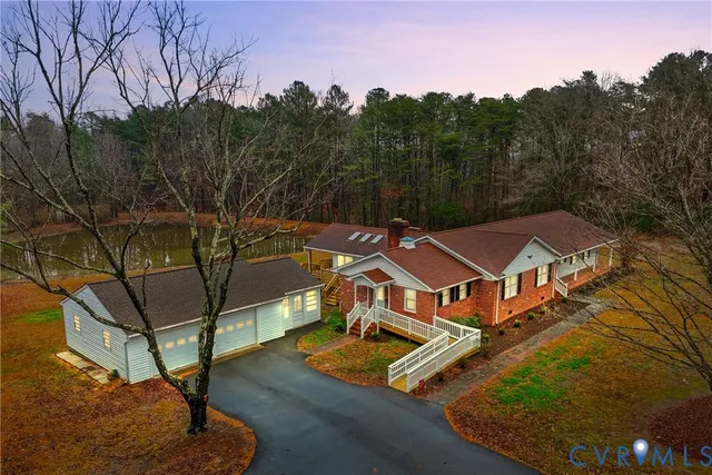 an aerial view of a house with swimming pool and mountain view