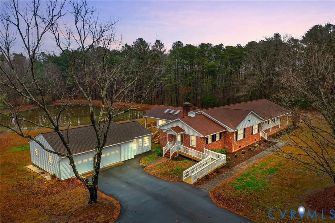 an aerial view of a house with swimming pool and mountain view