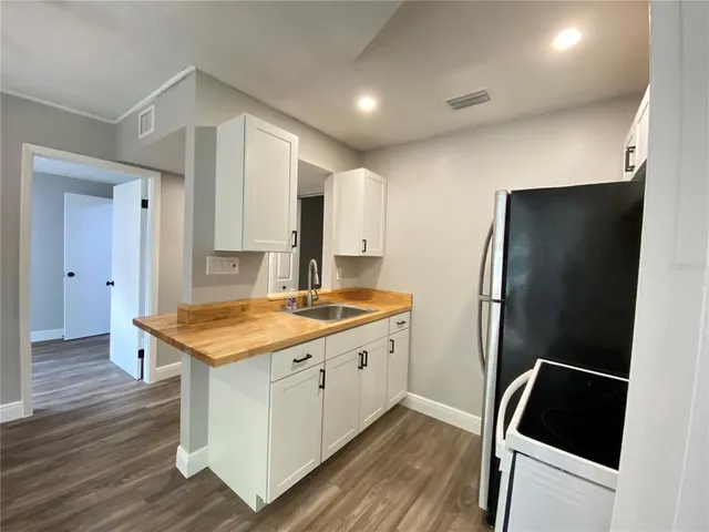 a kitchen with stainless steel appliances a refrigerator and a sink