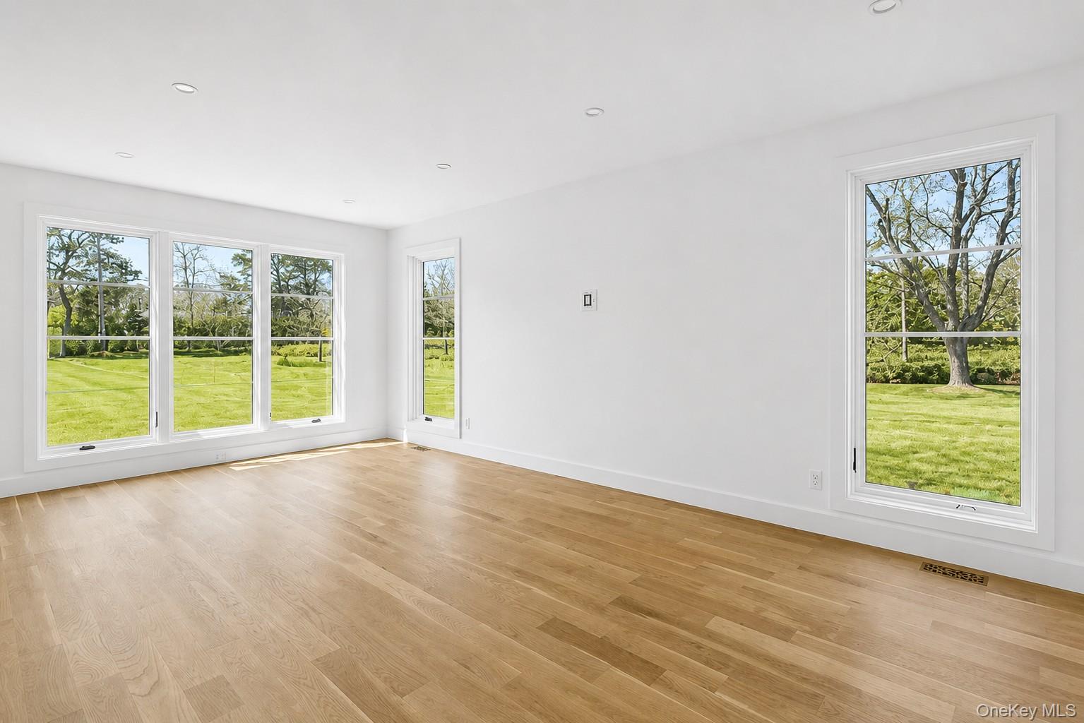 14 Ridge Road Southampton, NY 11968 - Photo 12 of 23 a view of an empty room with wooden floor and a window