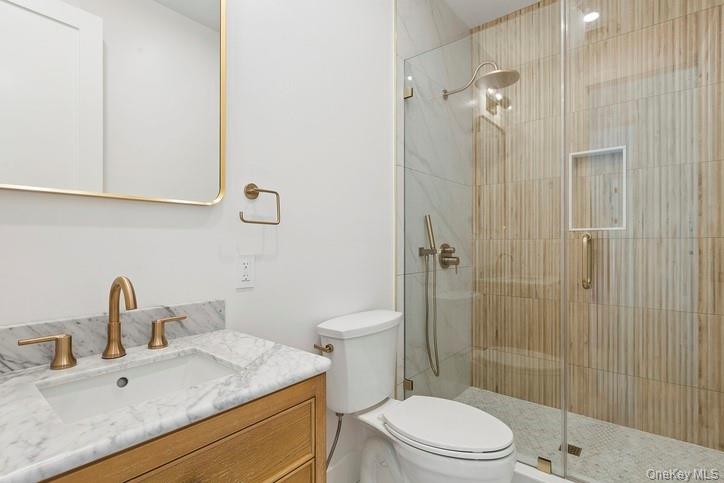 14 Ridge Road Southampton, NY 11968 - Photo 13 of 23 a bathroom with a granite countertop sink a toilet and shower
