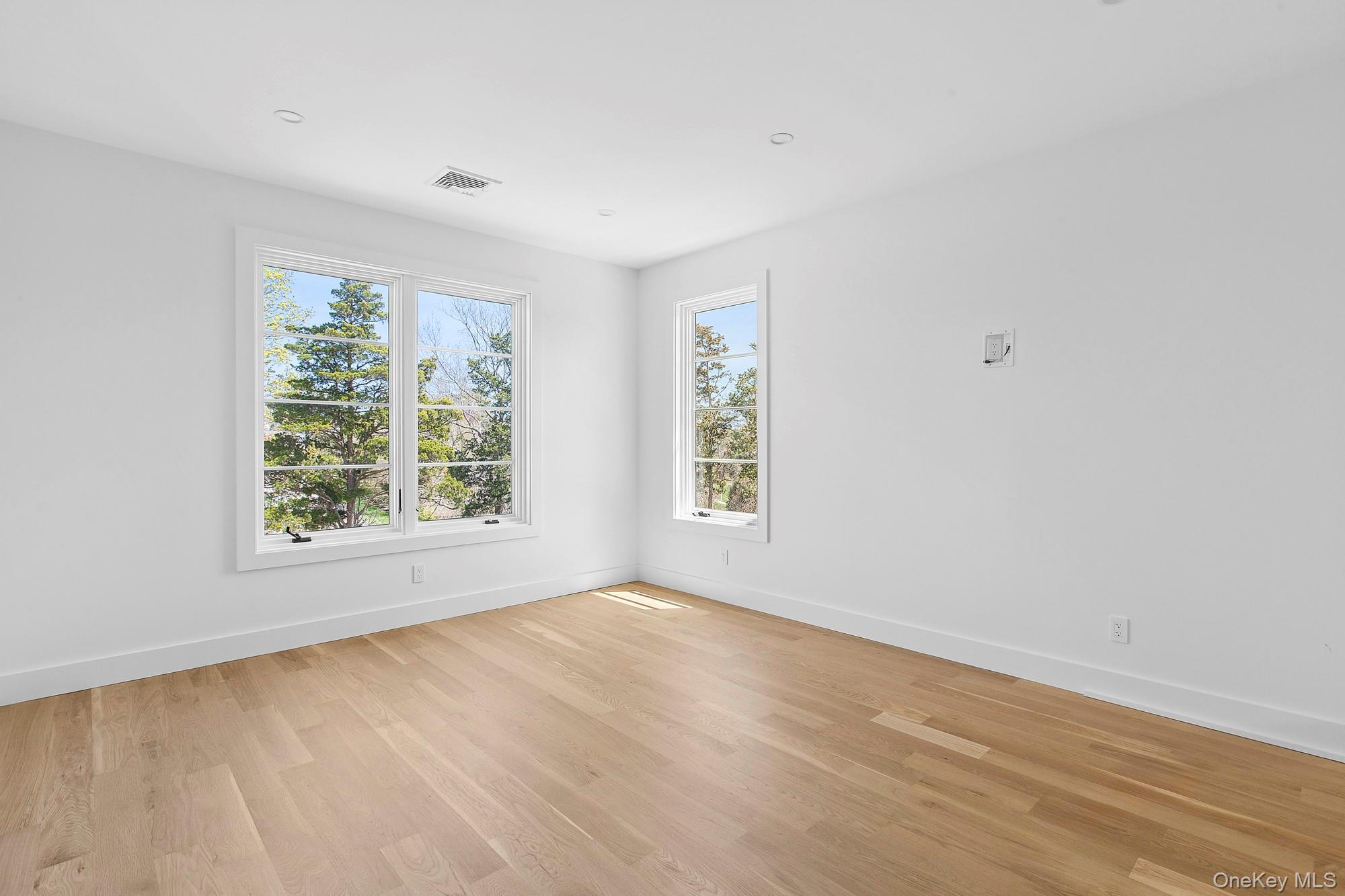 14 Ridge Road Southampton, NY 11968 - Photo 14 of 23 an empty room with wooden floor and windows