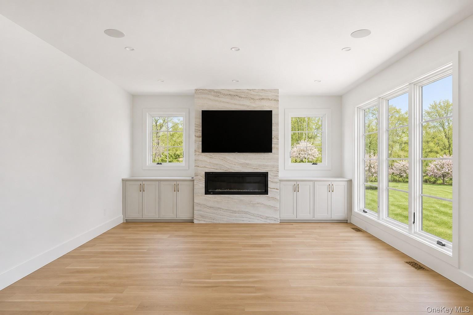 14 Ridge Road Southampton, NY 11968 - Photo 5 of 23 a view of a livingroom with a fireplace and a flat screen tv