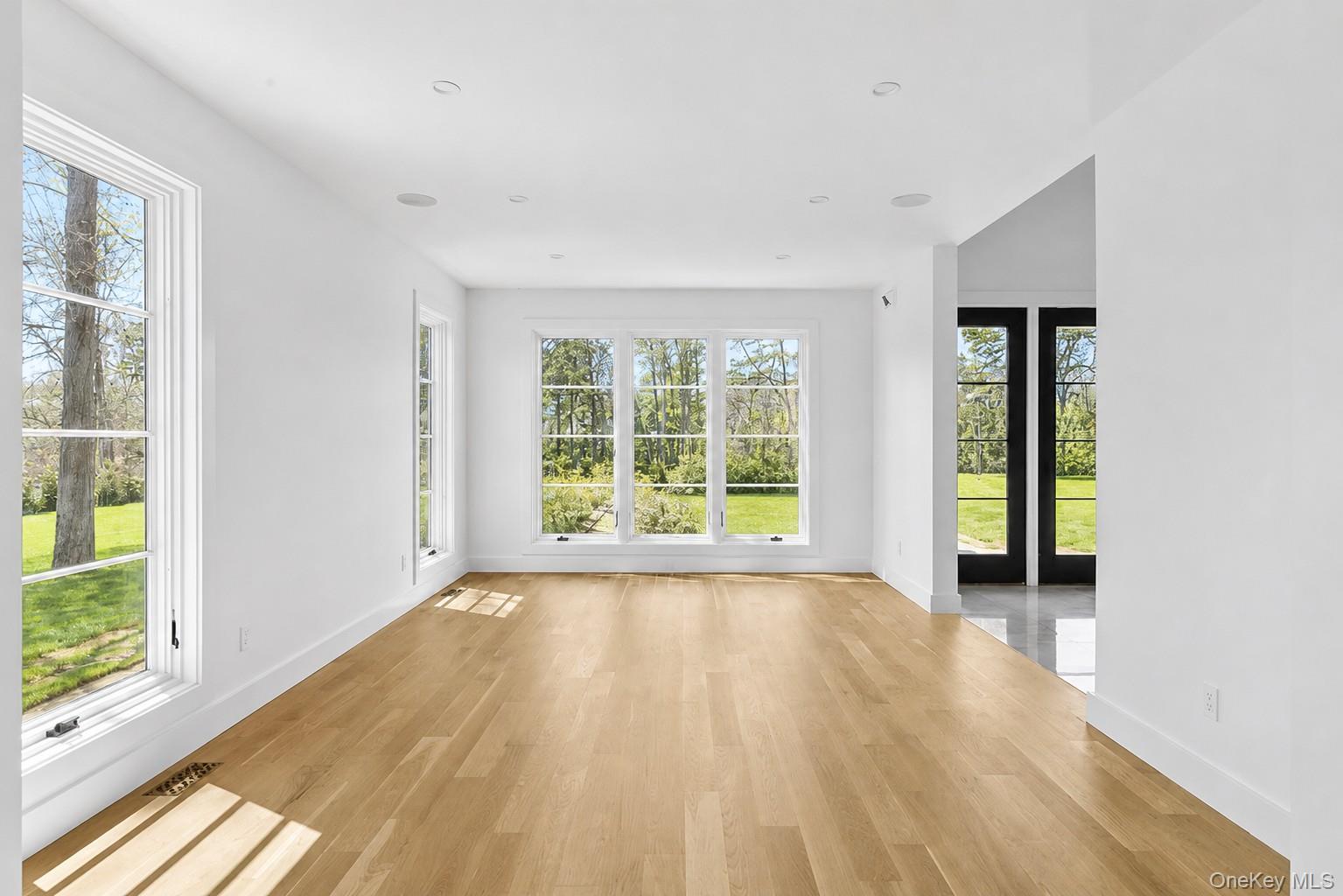 14 Ridge Road Southampton, NY 11968 - Photo 7 of 23 wooden floor in an empty room with a window