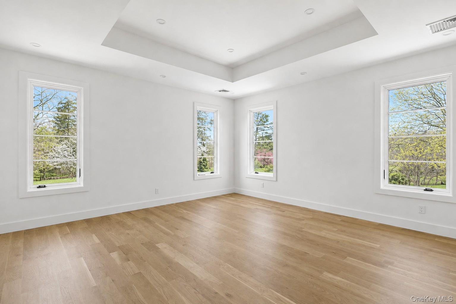 14 Ridge Road Southampton, NY 11968 - Photo 9 of 23 an empty room with wooden floor and windows
