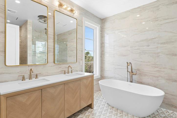 14 Ridge Road Southampton, NY 11968 - Photo 10 of 23 a bath room with a sink and a mirror