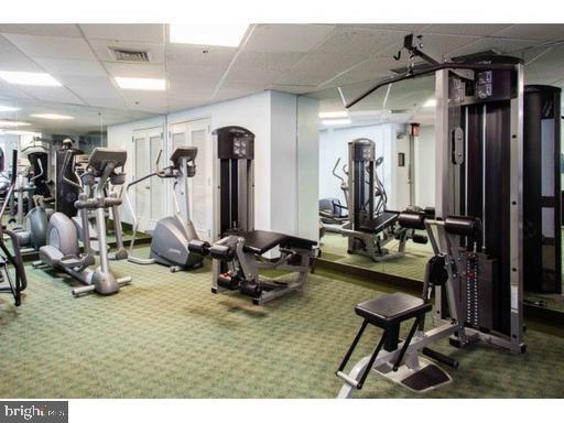 1600 Hagys Ford Road, Unit 7R Narberth, PA 19072 - Photo 18 of 20 a room with gym equipment and large mirror