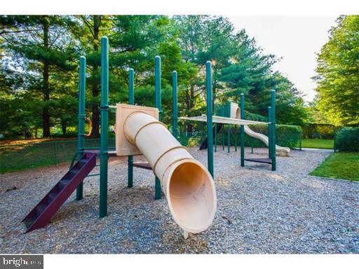 1600 Hagys Ford Road, Unit 7R Narberth, PA 19072 - Photo 19 of 20 a backyard of a house with a swing table and chairs
