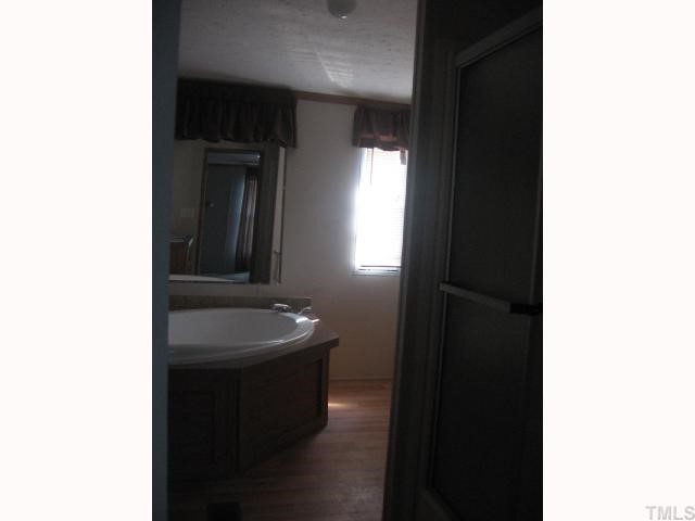 7621 Cassam Road Bahama, NC 27503 - Photo 6 of 8 a bathroom with a sink and a mirror