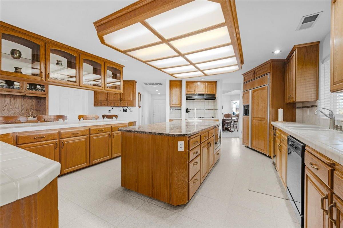 10925 Rusty Spur Lane Clovis, CA 93619 - Photo 17 of 94 a large kitchen with stainless steel appliances granite countertop a stove a sink and a refrigerator