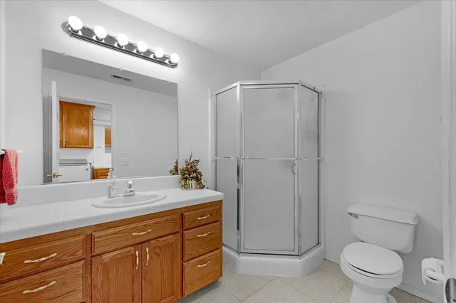 a spacious bathroom with a granite countertop sink mirror and bathtub