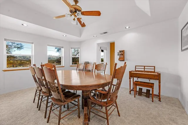 a kitchen with stainless steel appliances granite countertop wooden cabinets a sink and dishwasher a stove with wooden floor