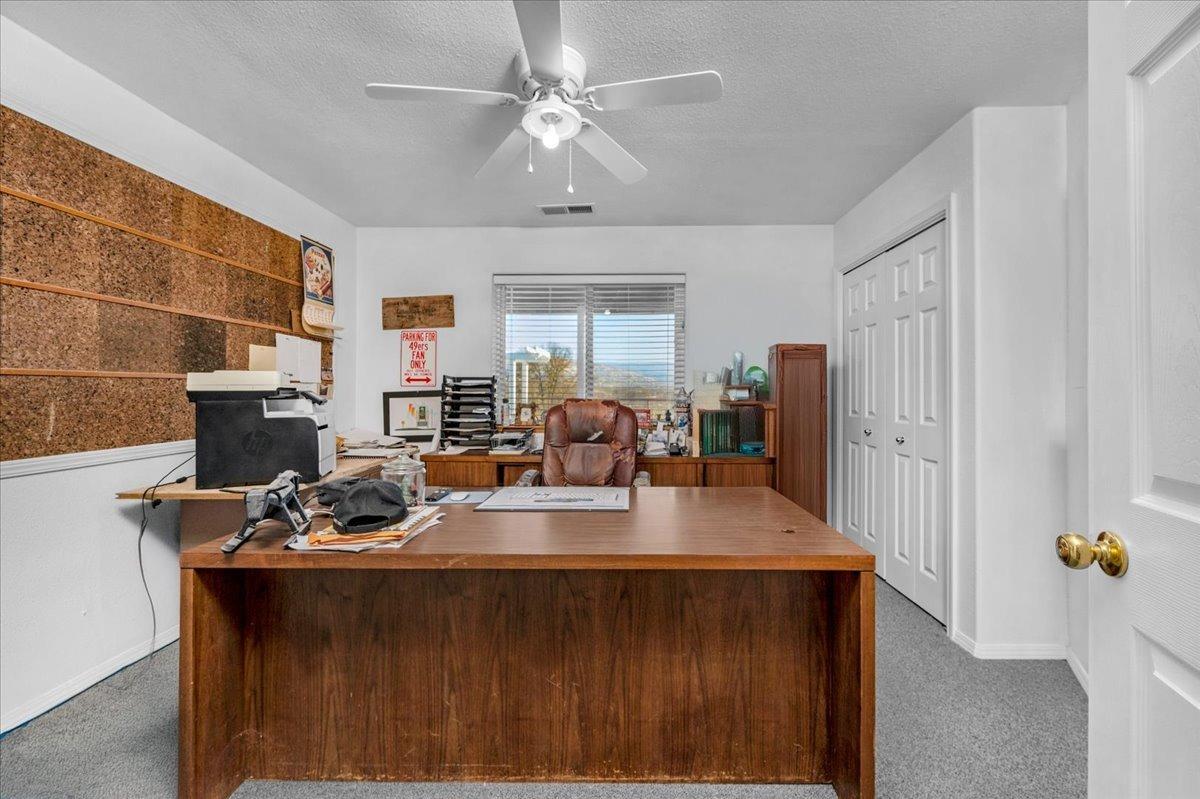 10925 Rusty Spur Lane Clovis, CA 93619 - Photo 25 of 94 a view of kitchen island with stainless steel appliances granite countertop sink stove and wooden floor