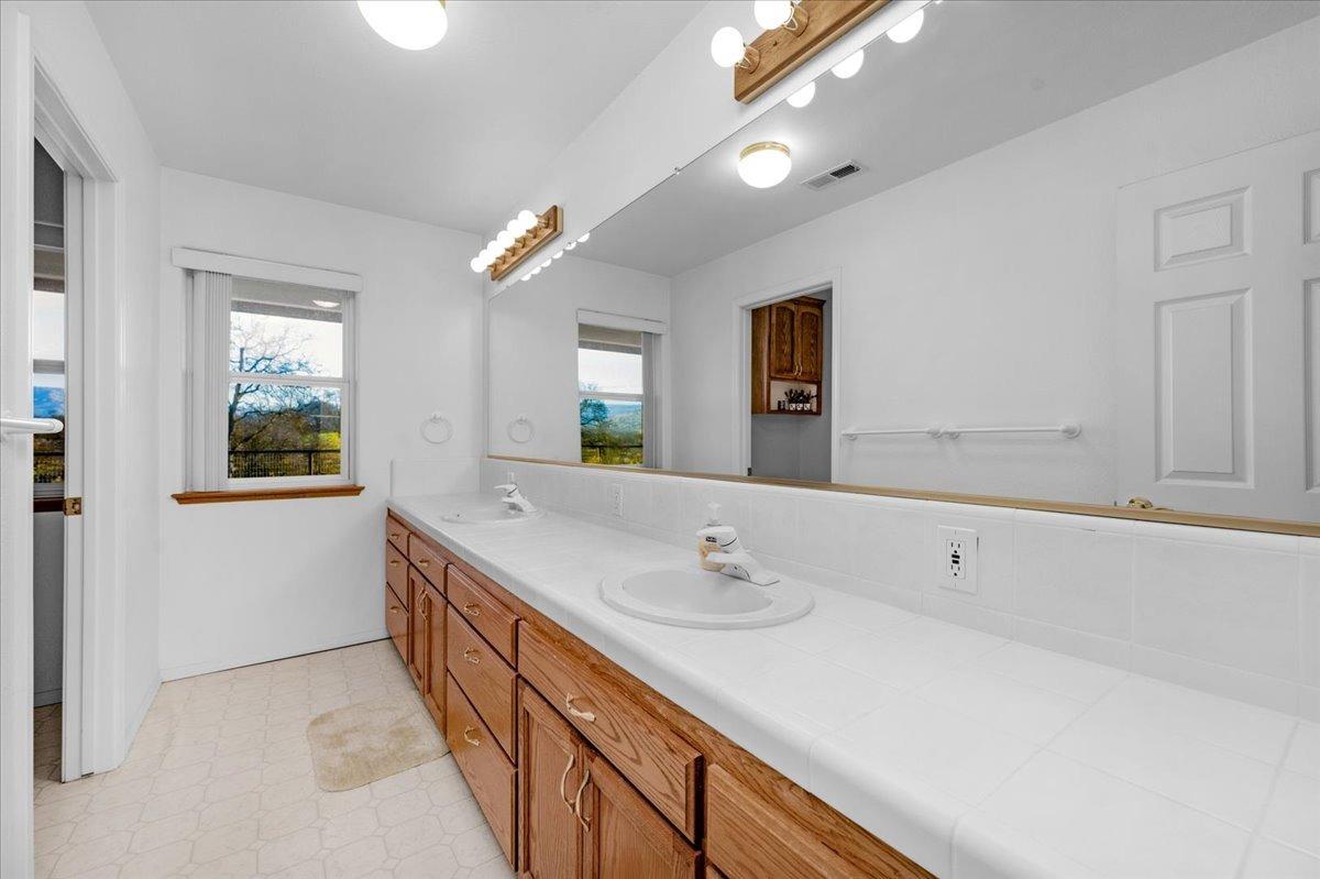 10925 Rusty Spur Lane Clovis, CA 93619 - Photo 26 of 94 a bathroom with a sink and a mirror