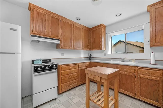 a view of backyard with swimming pool and seating space