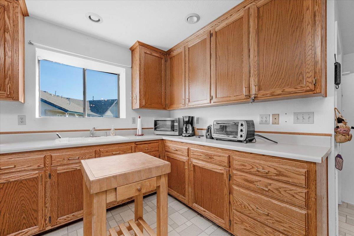 10925 Rusty Spur Lane Clovis, CA 93619 - Photo 46 of 94 a kitchen with stainless steel appliances granite countertop wooden cabinets a sink and dishwasher a stove with wooden floor
