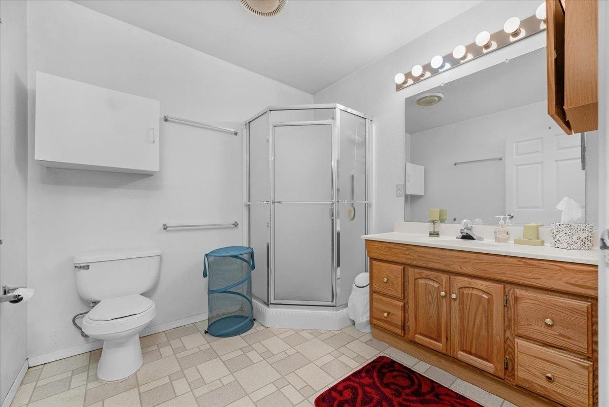 10925 Rusty Spur Lane Clovis, CA 93619 - Photo 47 of 94 a spacious bathroom with a toilet sink and mirror