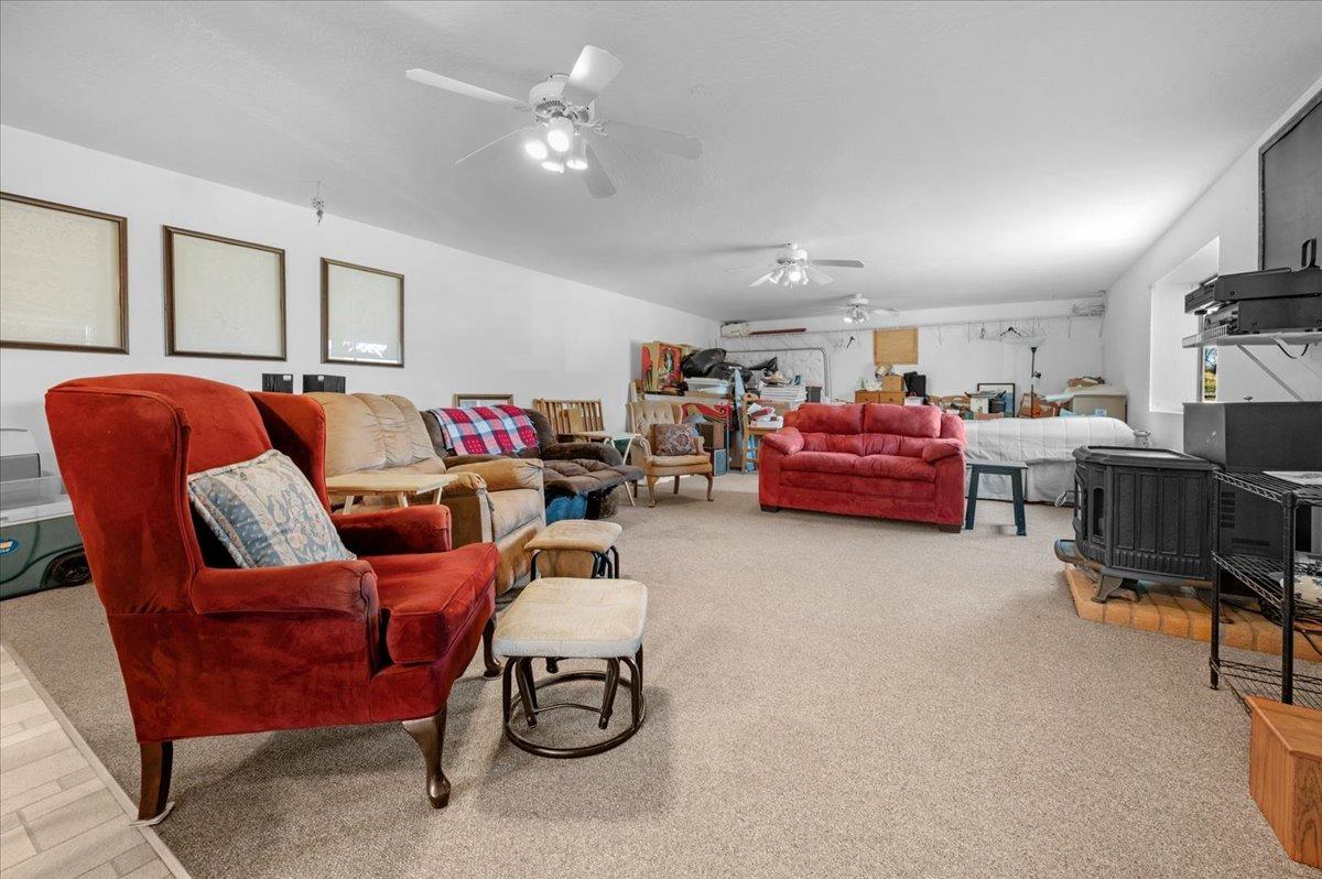 10925 Rusty Spur Lane Clovis, CA 93619 - Photo 48 of 94 a living room with furniture a ceiling fan and a window