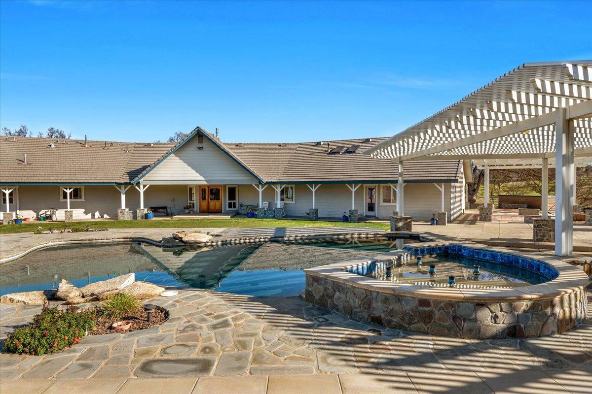 10925 Rusty Spur Lane Clovis, CA 93619 - Photo 59 of 94 a front view of a house with swimming pool having outdoor seating