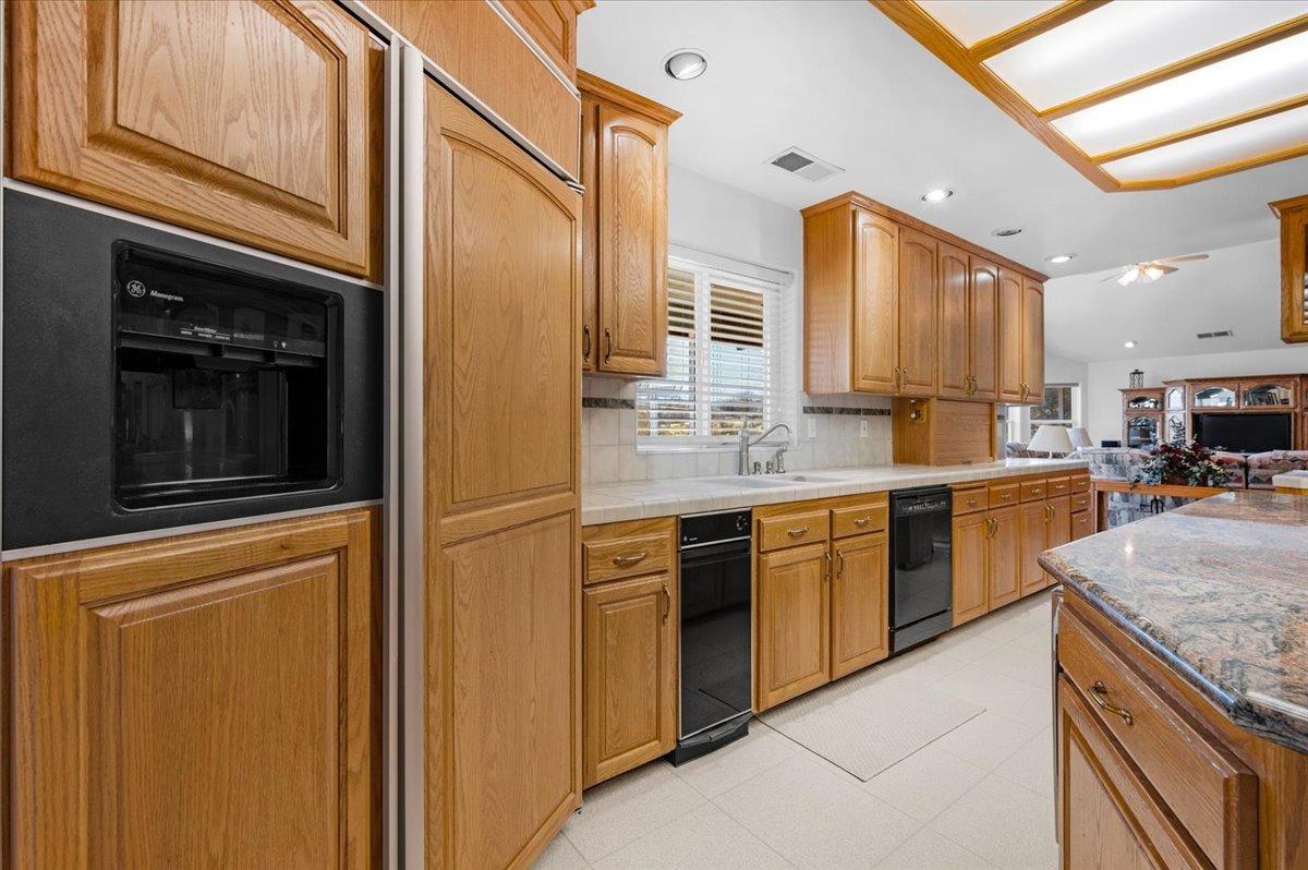 10925 Rusty Spur Lane Clovis, CA 93619 - Photo 10 of 94 a kitchen with stainless steel appliances granite countertop a refrigerator and a stove top oven