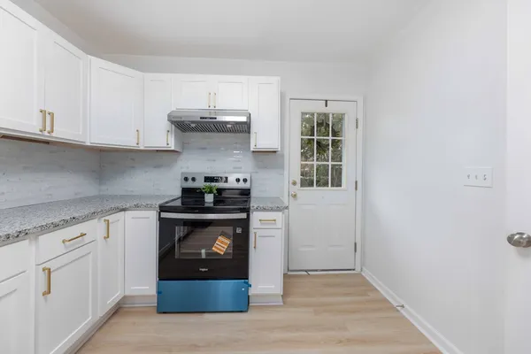 a kitchen with stainless steel appliances granite countertop a stove and a refrigerator