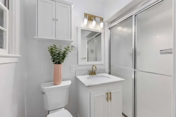 a bathroom with a toilet sink and mirror