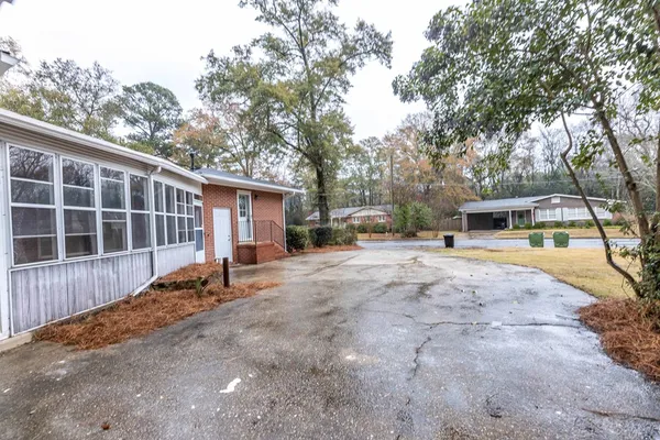 a front view of a house with a yard and seating space