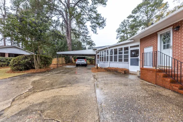 a view of a house with a yard and tree
