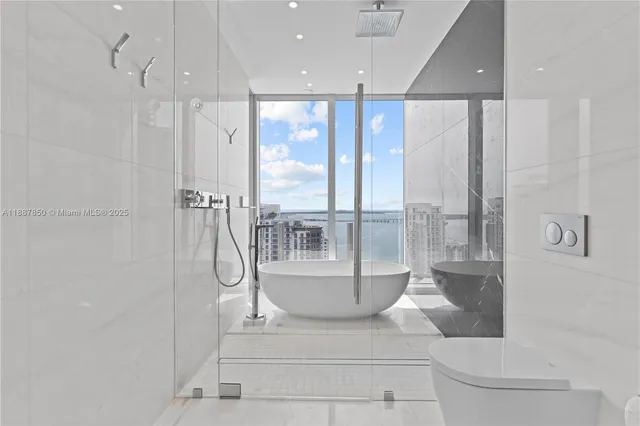 a bedroom with a large bed and a large window