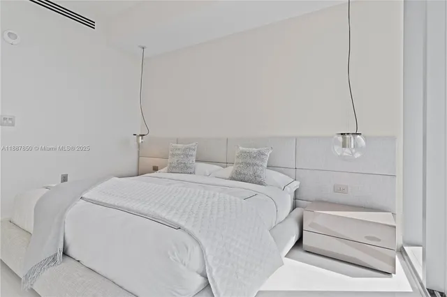 a bedroom with a bed and a lamp