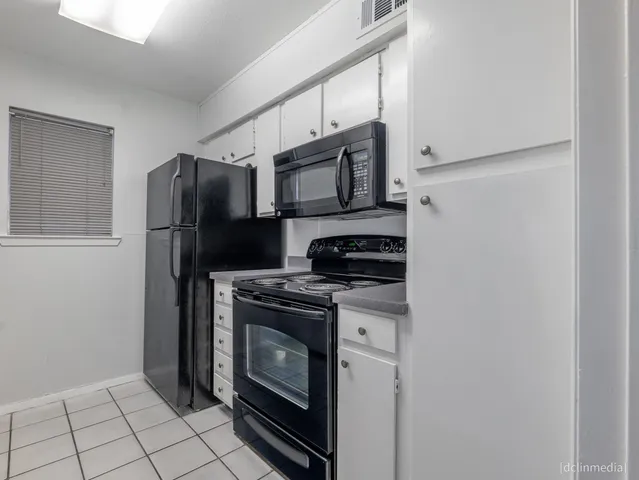 a view of a kitchen cabinets and chandelier