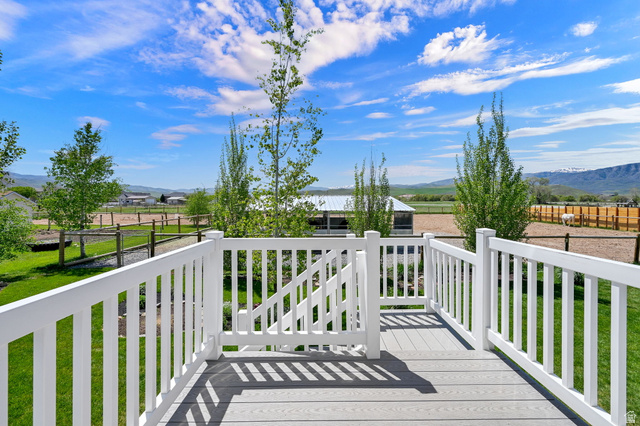 681 Island Road Morgan, UT 84050 - Photo 24 of 49 Composite deck with white railings and gate overlooking horse barn and pasture.